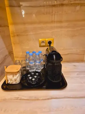 a tray with a tea kettle and bottles of water at Bright & Comfortable Marrakech Duplex in Oulad Akkou
