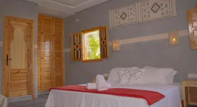 a bedroom with a white bed and a window at Bab Jbel in Ourika