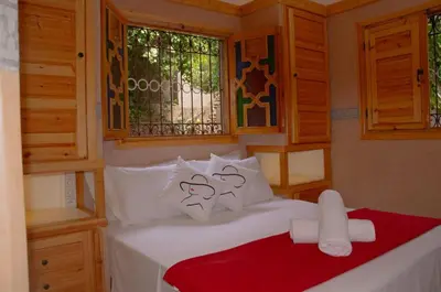 a bedroom with a bed with white pillows at Bab Jbel in Ourika