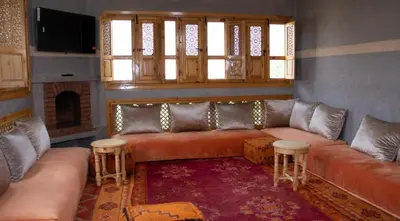 a living room with a couch and a fireplace at Bab Jbel in Ourika
