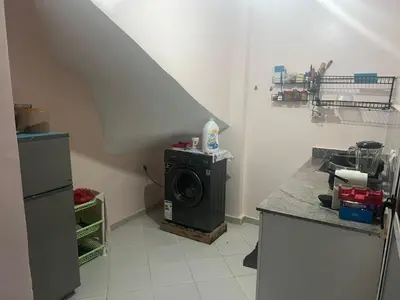 a kitchen with a washing machine in a room at dakhla extreme in Oulad Akkou