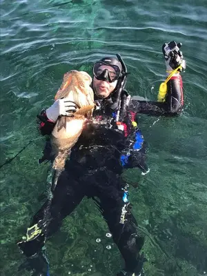 a man in the water holding a fish at dakhla extreme in Oulad Akkou