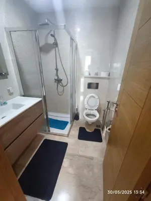 a bathroom with a shower and a toilet and a sink at Appartement luxe in Oulad Akkou