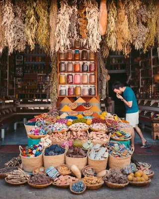 a man standing in front of a display of food at Desert Soul Camp in Erfoud