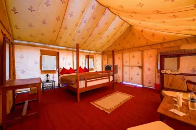 a bedroom with a bed and a desk in a room at Desert Soul Camp in Erfoud