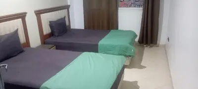 a room with two beds in a room at La perle de l'Atlas in Oulad Akkou