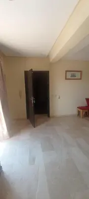 an empty room with a large room with a door at La perle de l'Atlas in Oulad Akkou