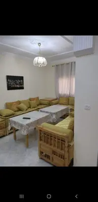 a living room with a couch and a table at Bousstan 1er in Oulad Akkou
