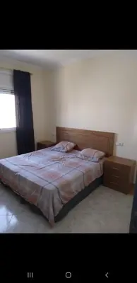a bedroom with a bed and a window at Bousstan 1er in Oulad Akkou