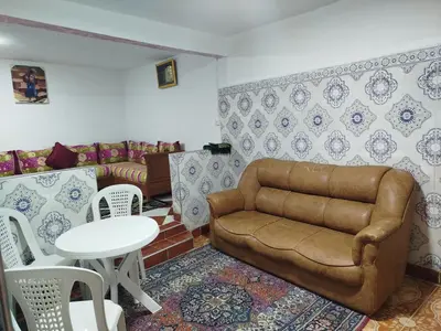 a living room with a couch and a table at Appartement REDA in Oulad Akkou