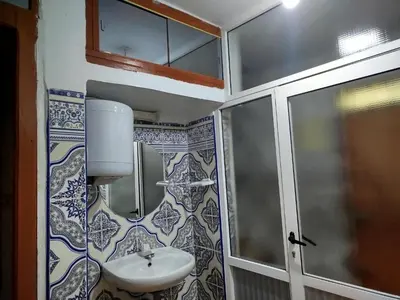 a small bathroom with a sink and a shower at Appartement REDA in Oulad Akkou