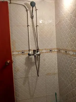 a shower with a blow dryer in a bathroom at Appartement REDA in Oulad Akkou
