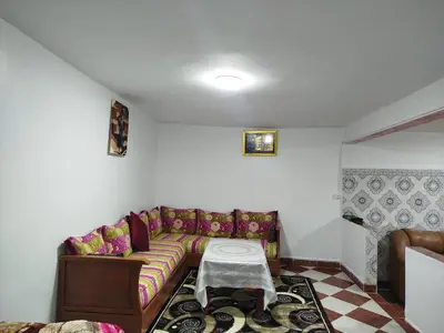 a living room with a couch and a table at Appartement REDA in Oulad Akkou