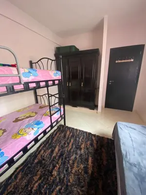 a room with two bunk beds and a rug at Family apartment between Casa and Mohammedia in Oulad Akkou