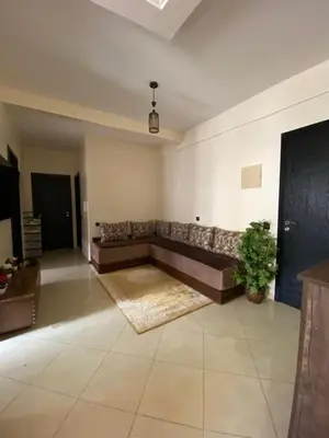 a large living room with a couch and a rug at Family apartment between Casa and Mohammedia in Oulad Akkou