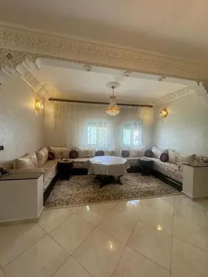 a living room with a couch and a table at Welcome to Tangier in Oulad Akkou