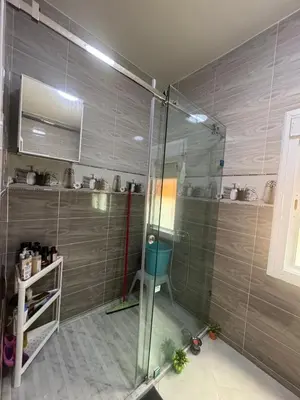 a bathroom with a shower with a glass door at Welcome to Tangier in Oulad Akkou