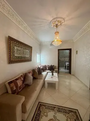 a living room with a couch and a table at Welcome to Tangier in Oulad Akkou