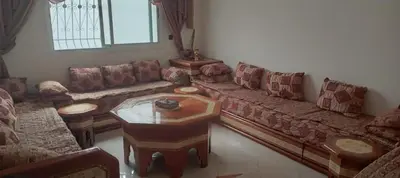 a living room with a couch and a coffee table at Dar mustapha in Oulad Akkou