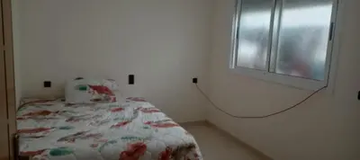 a bedroom with a bed and a window at Dar mustapha in Oulad Akkou