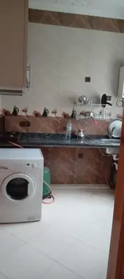 a kitchen with a counter and a washing machine at Dar mustapha in Oulad Akkou