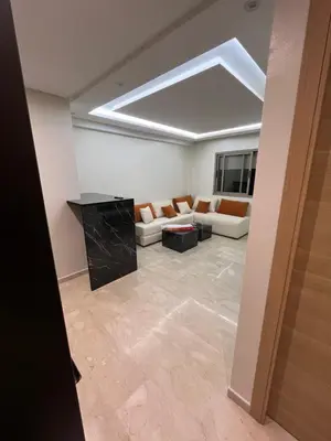 a living room with a couch and a table at Appartement Moderne Hyper Centre in Oulad Akkou