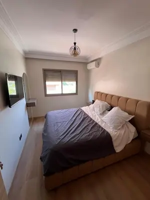 a bedroom with a large bed in a room at Appartement Moderne Hyper Centre in Oulad Akkou