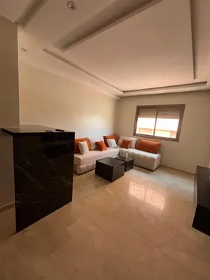 a large living room with couches and a window at Appartement Moderne Hyper Centre in Oulad Akkou