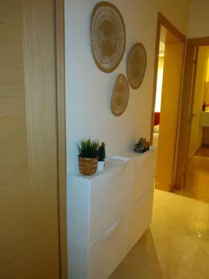 a white counter with a potted plant on a wall at BOUZNIKA shems premium in Oulad Akkou