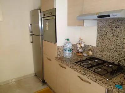 a kitchen with a stove and a refrigerator at BOUZNIKA shems premium in Oulad Akkou