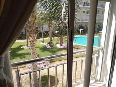 a view of a palm tree from a balcony at BOUZNIKA shems premium in Oulad Akkou