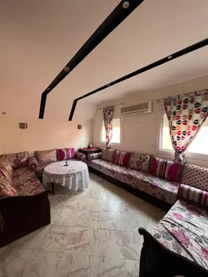 a large living room with couches and a table at Cozy apartment in center in Beni Mellal