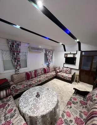 a living room with a couch and a table at Cozy apartment in center in Beni Mellal