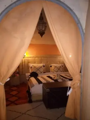 a bedroom with a bed with a canopy at LuXURY SAHARA CAMP in Merzouga