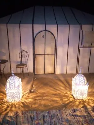 two lights in a tent with a table and chairs at LuXURY SAHARA CAMP in Merzouga
