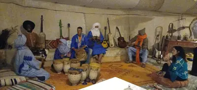 a painting of a group of people in a room with instruments at LuXURY SAHARA CAMP in Merzouga