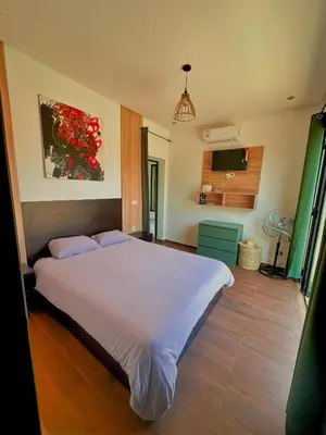 a bedroom with a white bed and a television at Chic Duo Villas with Pool & Hammam in Ourika