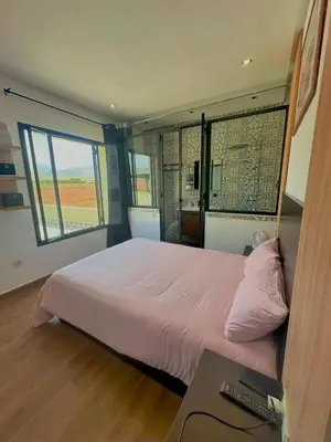 a bedroom with a bed and a desk with a keyboard at Chic Duo Villas with Pool & Hammam in Ourika