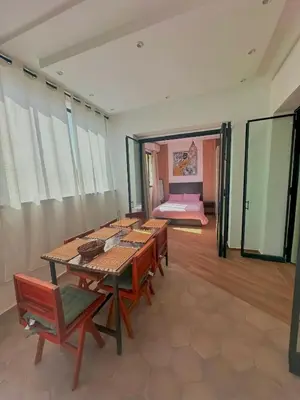 a room with a table and chairs and a bedroom at Chic Duo Villas with Pool & Hammam in Ourika