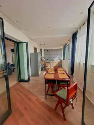 a living room with a table and a chair at Chic Duo Villas with Pool & Hammam in Ourika