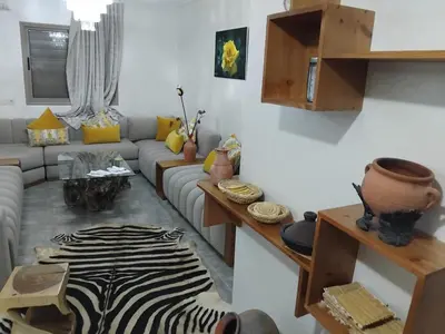 a living room with a couch and a zebra rug at Appartement moderne - Marrakech in Oulad Akkou
