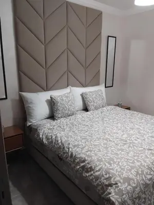a bedroom with a large bed with two pillows at Appartement moderne - Marrakech in Oulad Akkou