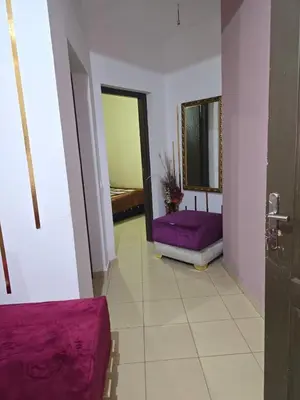 a hallway with a purple couch and a mirror at caprice apparemment in Ifrane