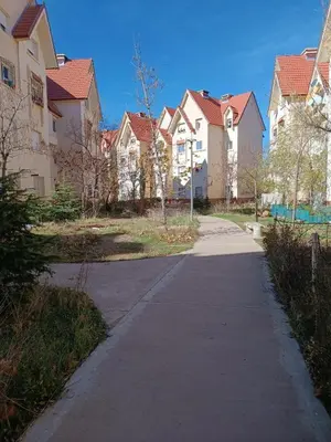 a street in a residential neighborhood with houses at caprice apparemment in Ifrane