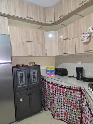 a kitchen with a refrigerator and a counter top at caprice apparemment in Ifrane