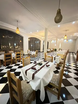 a restaurant with a black and white checkered floor at iMei Lux Camp \u7231\u6885\u91ce\u5962\u8425\u5730 in Lac Yasmins