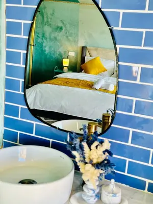 a bathroom with a mirror and a sink and a bed at iMei Lux Camp \u7231\u6885\u91ce\u5962\u8425\u5730 in Lac Yasmins