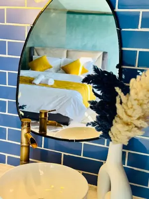 a bathroom with a mirror and a bed and a sink at iMei Lux Camp \u7231\u6885\u91ce\u5962\u8425\u5730 in Lac Yasmins