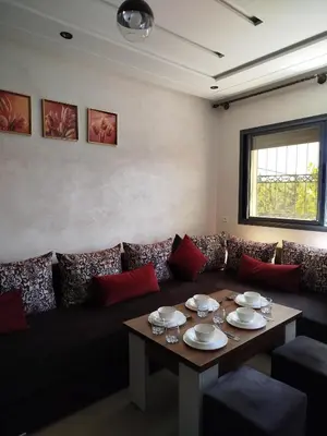 a living room with a couch and a table at Le Refuge de Vittel 2 in Ifrane