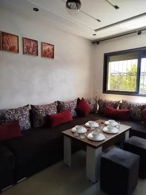 a living room with a couch and a table at Le Refuge de Vittel 2 in Ifrane